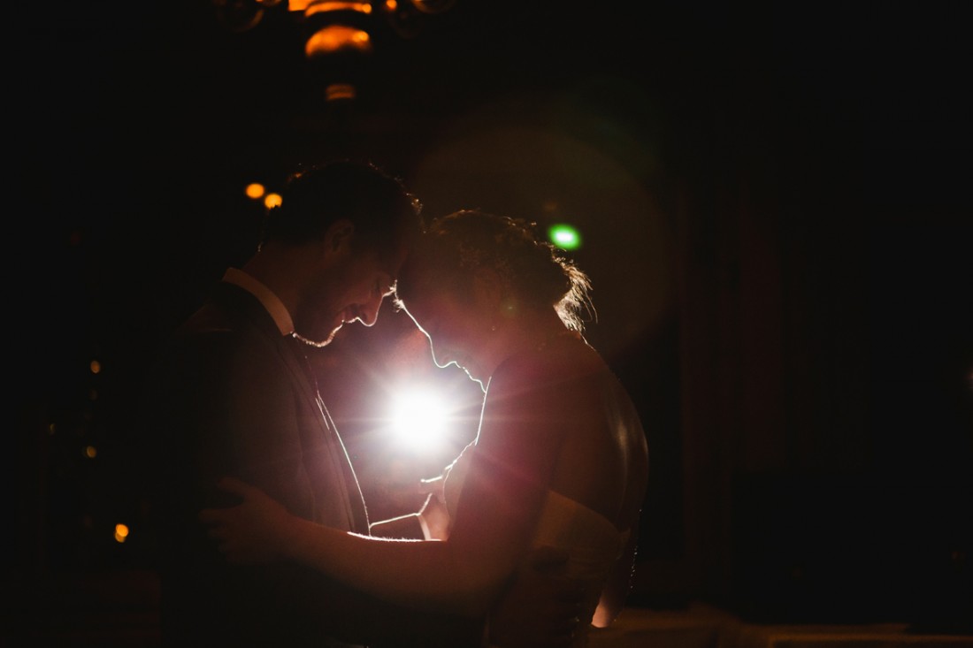 back lit first dance of bride and groom in the reception hall of edgewater lodge, Whistler