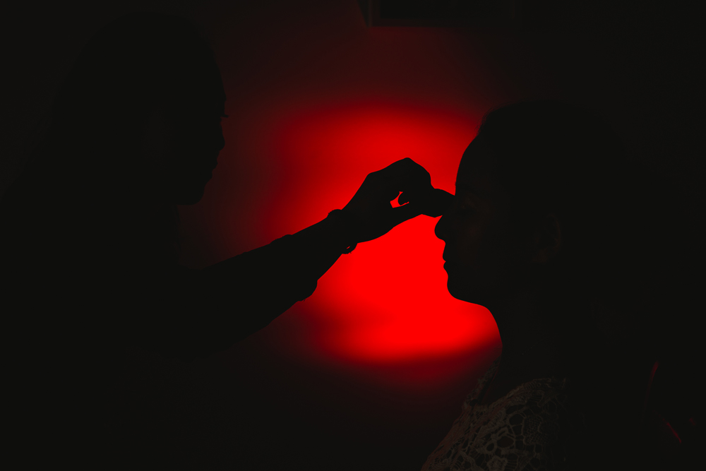 silouette of the bride getting make up done