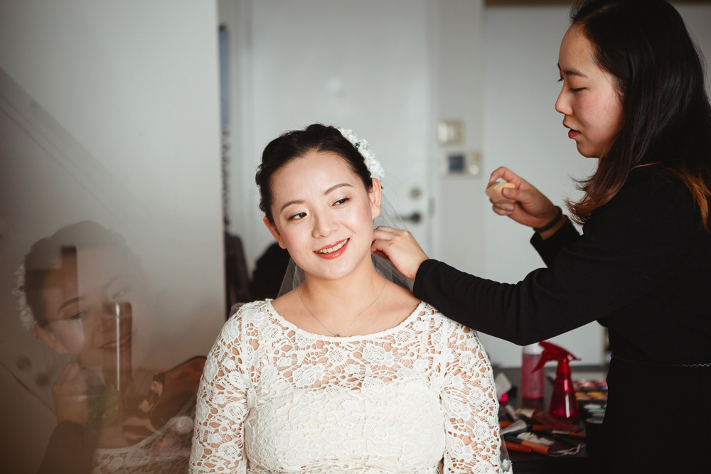bride having her hair done at home in downtown montreal by the make up artist and fashion designer Kelly and heading to vieux port steakhouse for her winter intimate wedding