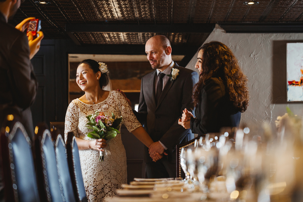 bride and groom holding hands before their ceremony in their ceremony in vieux port steakhouse, Montreal