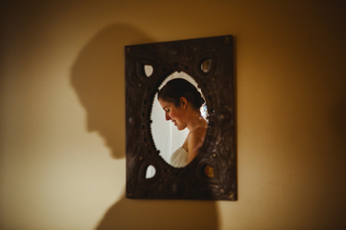 bride in the mirror in contrast against her own shadow